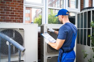 technician-inspecting-air-conditioner