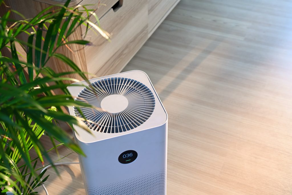 Portable air purifier operating in modern Orlando Florida home to improve indoor air quality and reduce airborne allergens by English Air.