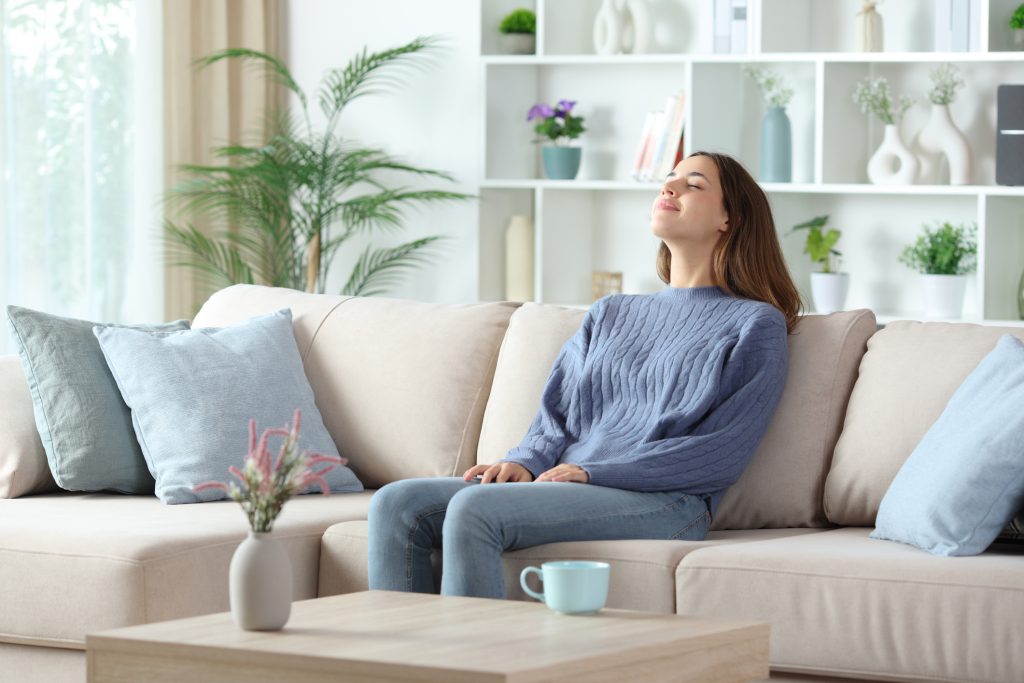Relaxed woman breathing fresh clean indoor air in Orlando Florida home with air purifier system installed by English Air.